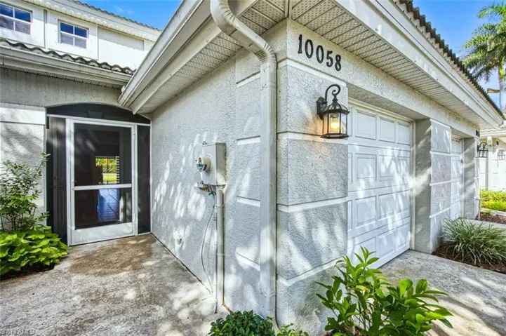 View of side of property with stucco siding and a tile roof