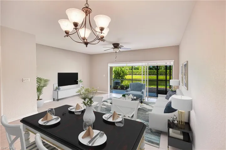 Dining room featuring a chandelier, ceiling fan, and light tile patterned flooring. Virtually Staged