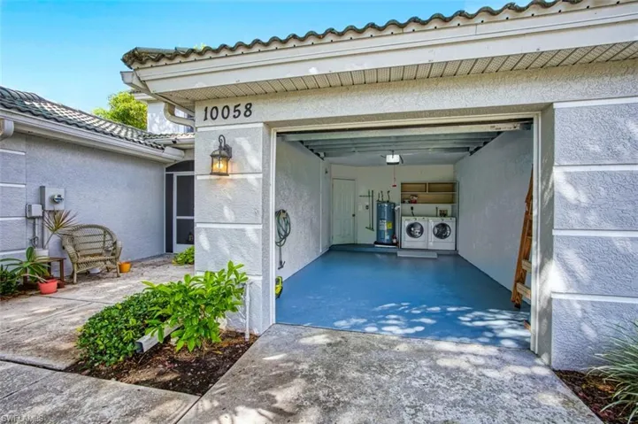 Garage with washer and dryer and water heater