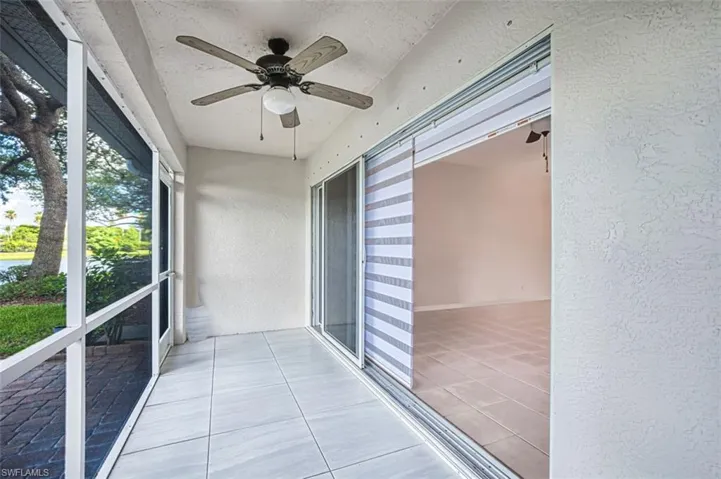 Unfurnished sunroom with ceiling fan