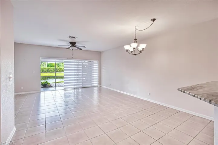 Living/Dining area with a chandelier, a ceiling fan, and light tile patterned floors