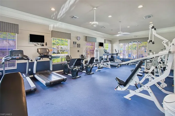 Workout area featuring crown molding, healthy amount of natural light, and recessed lighting