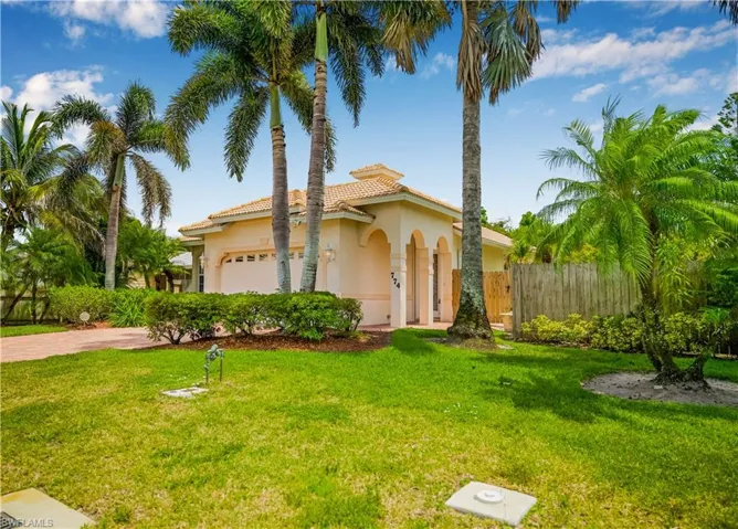Mediterranean / spanish-style house featuring an attached garage, stucco siding, driveway, and a tile roof