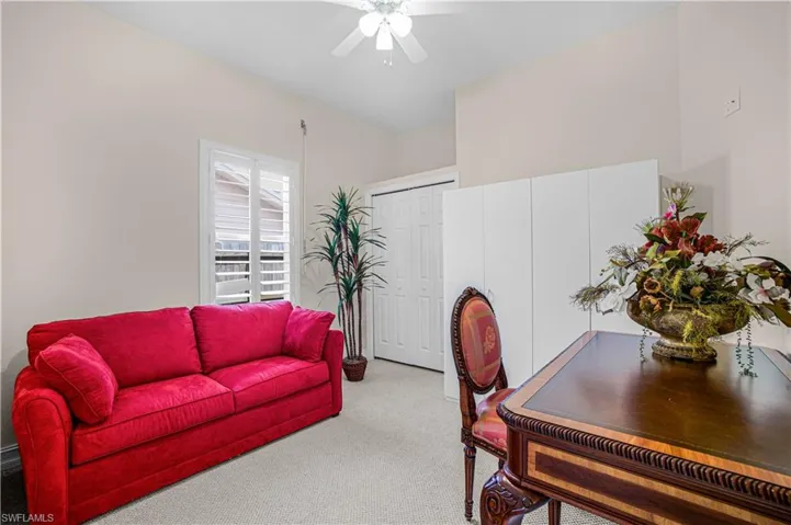 Home office featuring carpet and a ceiling fan