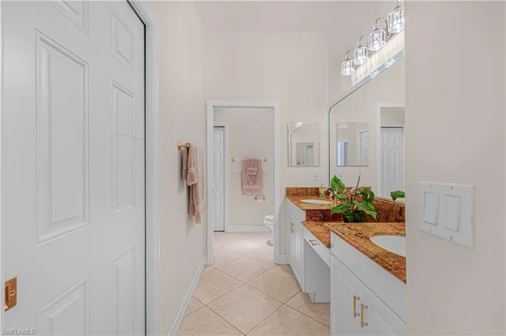 Full bath with vanity and tile patterned flooring