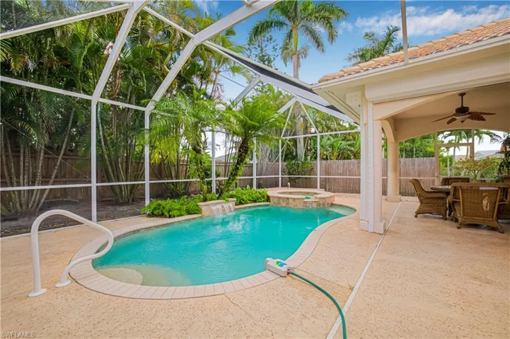 View of swimming pool with a patio area, a fenced backyard, a ceiling fan, and a lanai