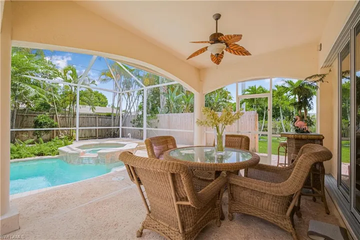 Sunroom featuring a hot tub, a ceiling fan, and vaulted ceiling