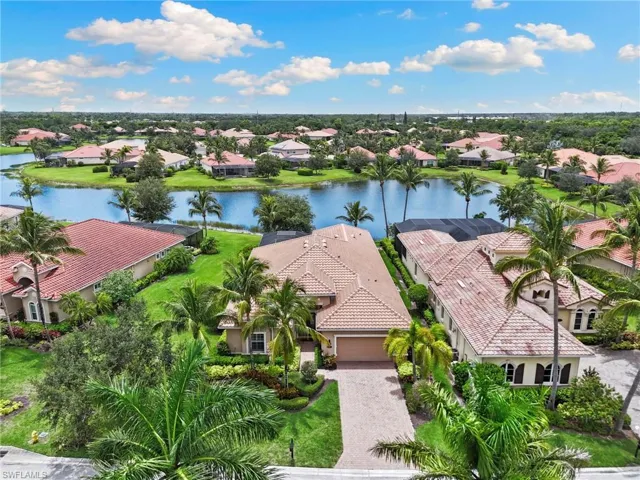 Aerial view of residential area featuring a nearby body of water