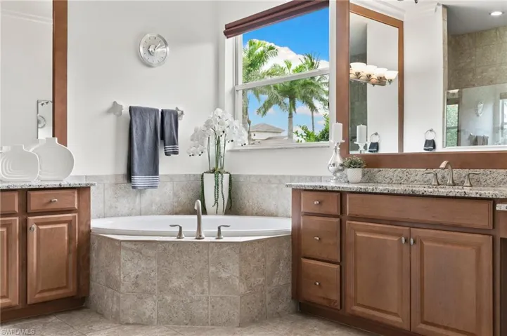 Full bathroom featuring vanity, a garden tub, and tile patterned floors