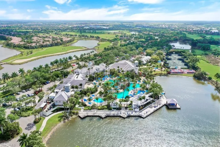 Aerial overview of property's location with a large body of water and a golf club