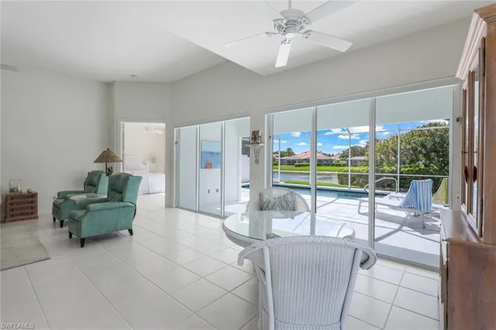 Tiled living room featuring ceiling fan