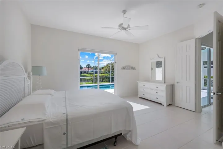 Bedroom with access to outside, ceiling fan, and light tile floors