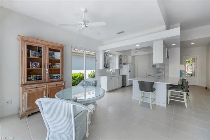 Tiled dining room featuring sink and ceiling fan
