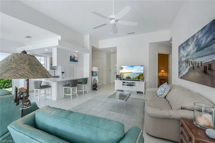Tiled living room featuring ceiling fan