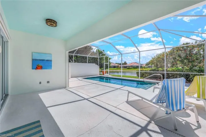 View of swimming pool featuring a lanai and a patio area