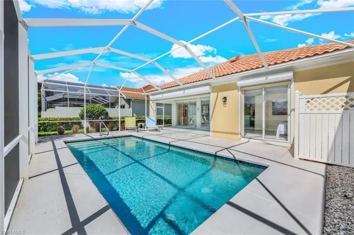 View of swimming pool with a patio area and a lanai