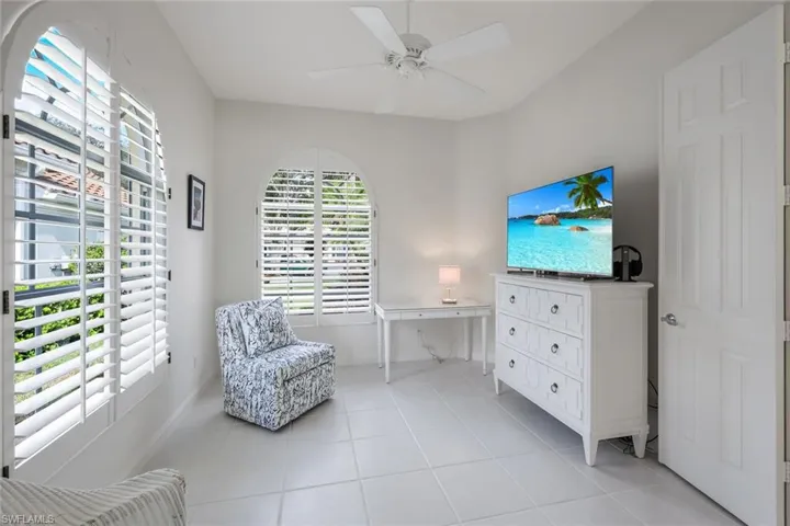Sitting room featuring ceiling fan and light tile floors