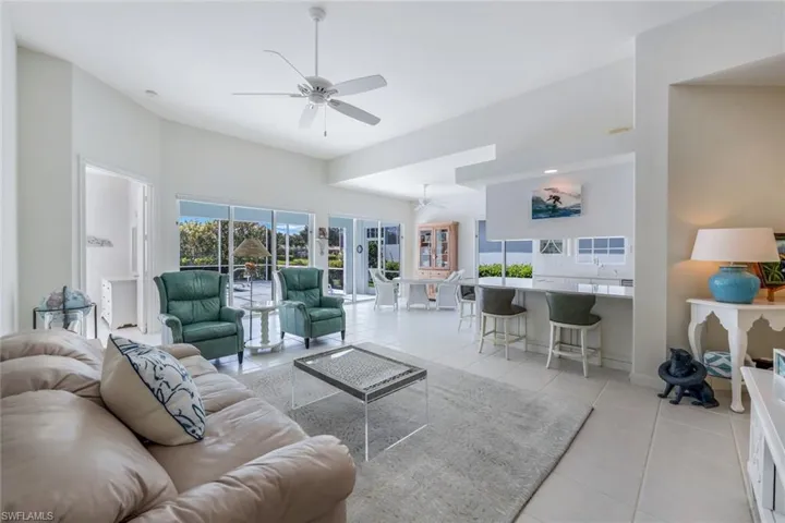 Living room featuring ceiling fan and light tile flooring