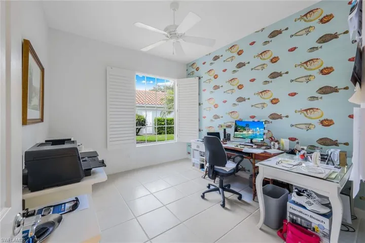 Tiled office featuring ceiling fan