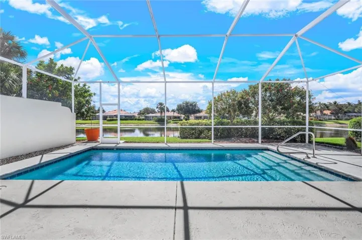 View of swimming pool with a lanai and a water view