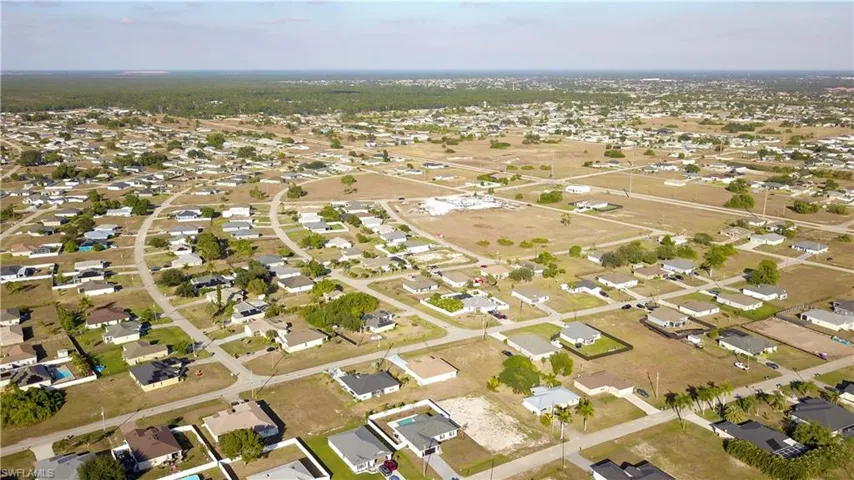 Aerial overview of property's location featuring nearby suburban area