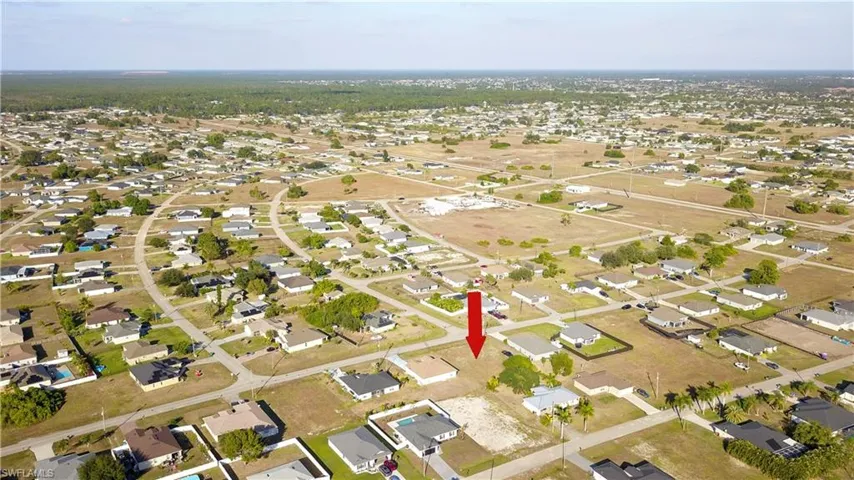 Aerial overview of property's location featuring nearby suburban area