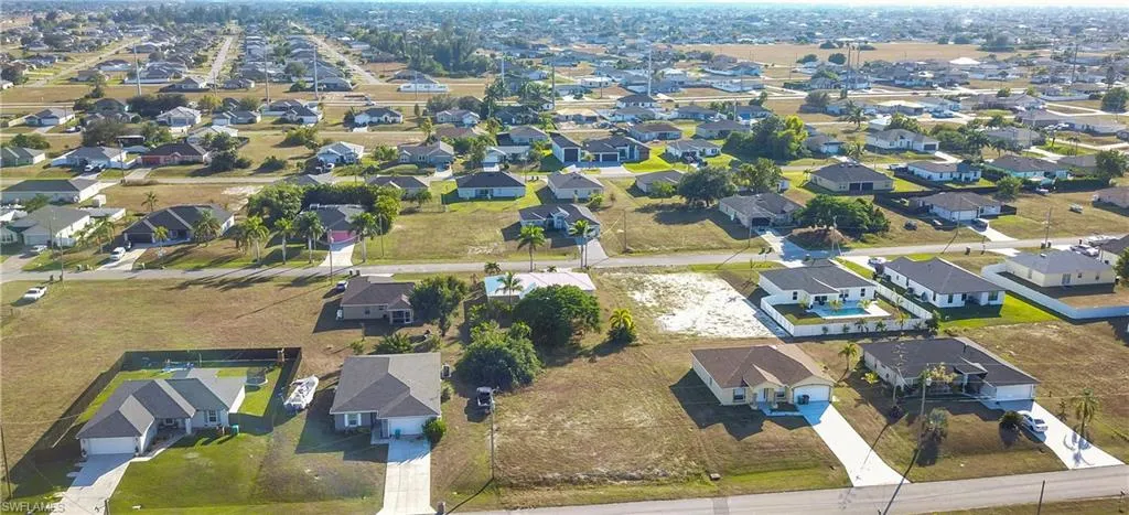 Aerial view of property's location featuring nearby suburban area