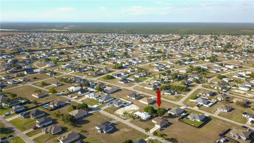 Aerial view of property's location with nearby suburban area