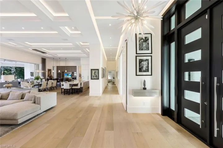 The grand foyer welcomes guests with a stunning entry, setting the tone for the entire home.