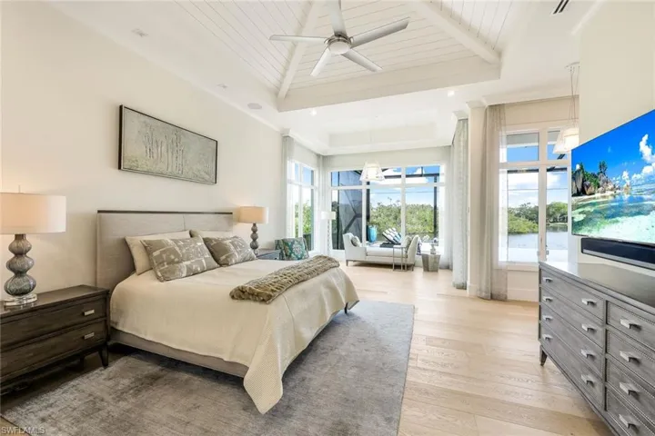 The primary bedroom suite offers a spacious sitting area with views of the serene lake and bird watching!