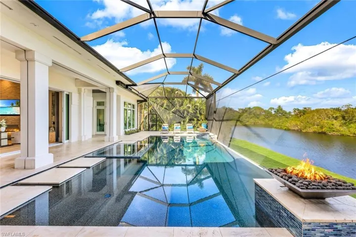 Notice the vanishing edge pool, the glowing fire pits and the pebble tech pool finish.