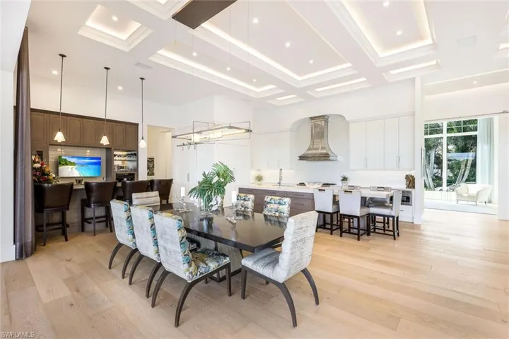 The wide oak flooring seamlessly connects the dining area to the adjacent living spaces.