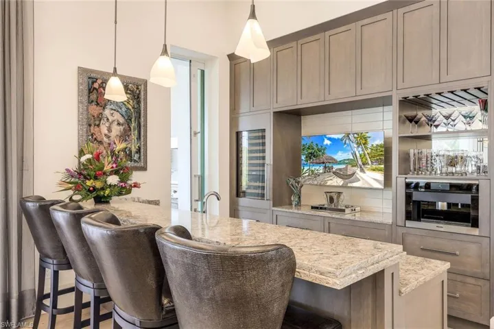 The bar area is designed for both casual and formal entertaining, offering ample space for socializing.