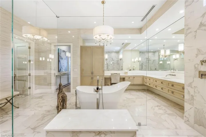 Walk-in shower is designed with intricate tile work, adding both beauty and function.