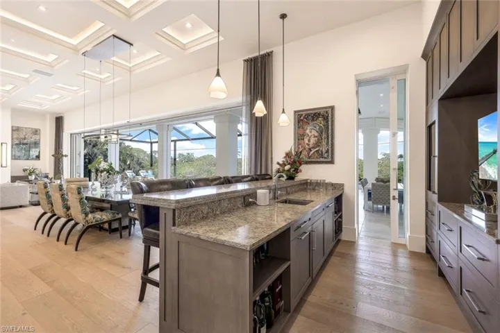 The stylish bar area is conveniently located off the kitchen and dining, offering easy access for entertaining.