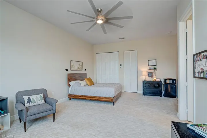 Upper Ensuite bedroom #5 featuring multiple closets and a ceiling fan