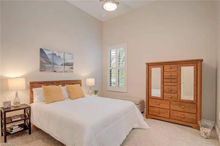 Ensuite Bedroom #4 featuring light colored carpet and ceiling fan