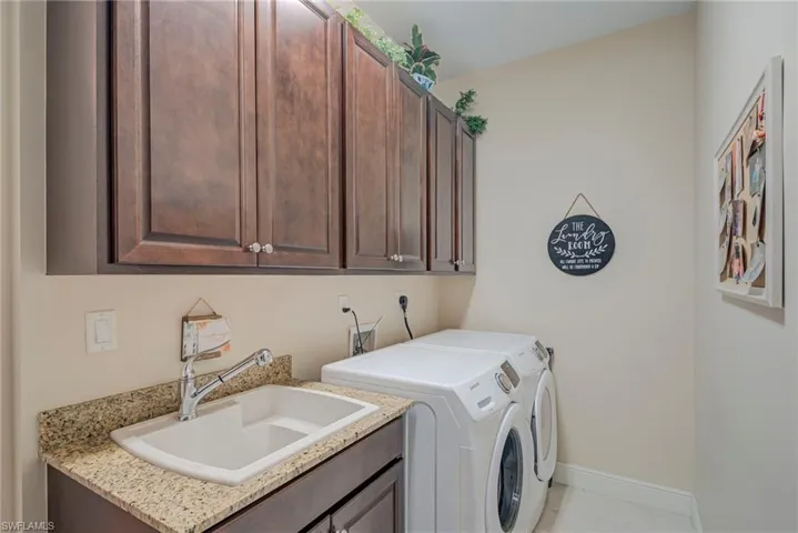 Laundry room with washing machine and clothes dryer and cabinet space