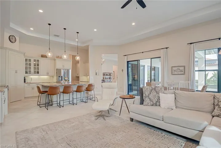 Living room with recessed lighting, ceiling fan, a high ceiling, and light tile patterned floors