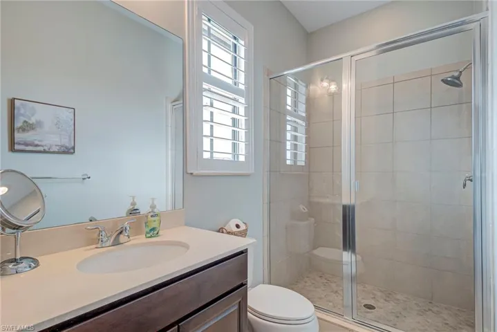 Upper ensuite full bathroom featuring vanity and a shower stall