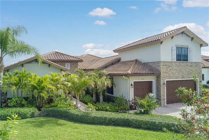 Mediterranean house featuring stucco/stone siding, and paver driveway