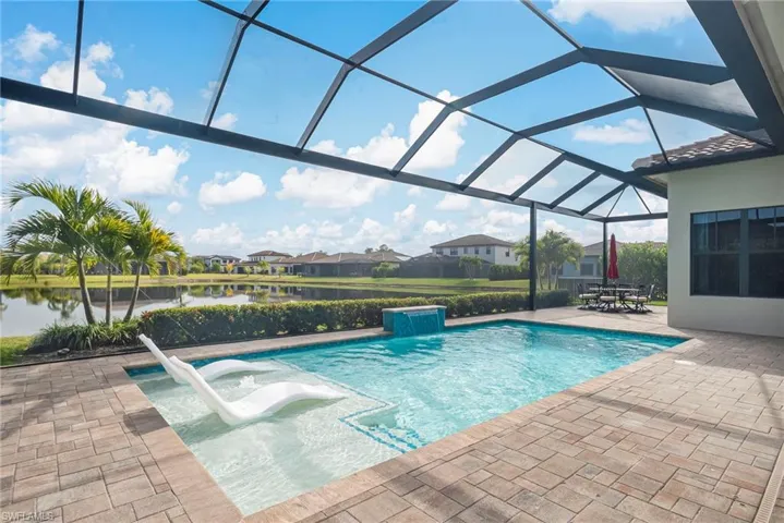 Outdoor pool with 65ft wide screened lanai