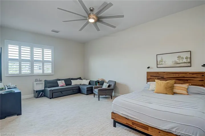 Upper ensuite bedroom #5 featuring a ceiling fan and baseboards