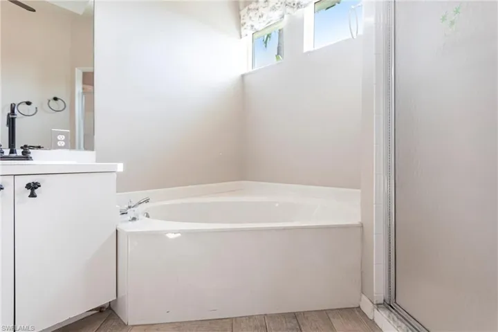 Bathroom featuring vanity, Imported Italian Ceramic tiles, and shower with lovely light coming in from top windows.