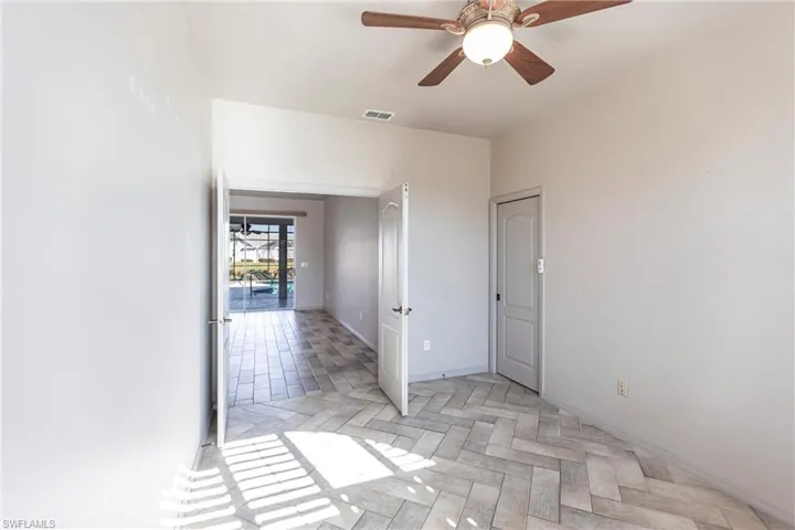 Featuring double doors and pocket door to primary bedroom and bathroom featuring Imported Italian Ceramic tiles.