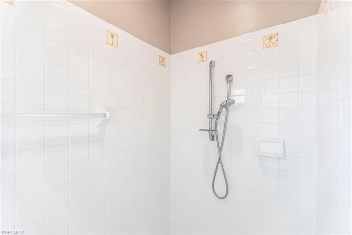 Bathroom with a tile shower.