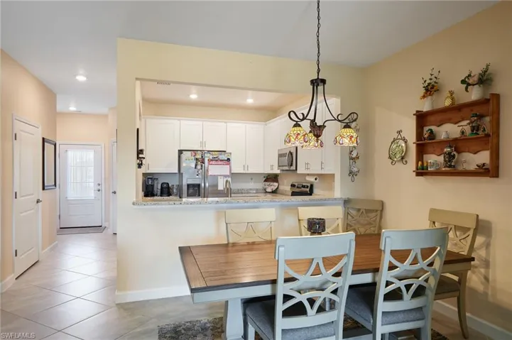 Dining area with light tile patterned floors