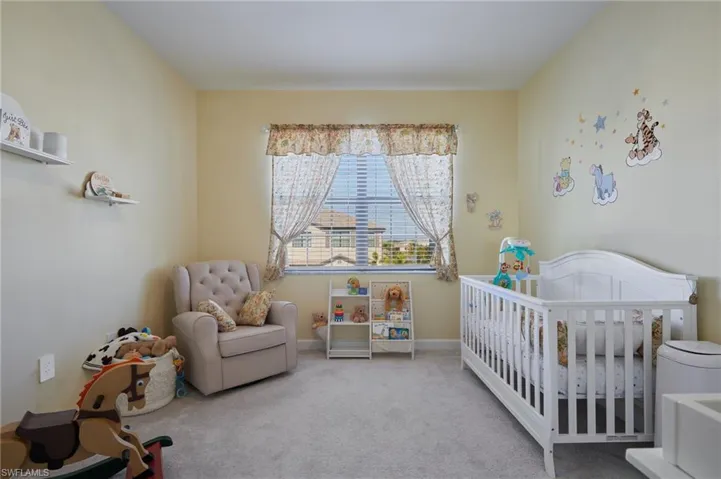 Carpeted bedroom with a crib