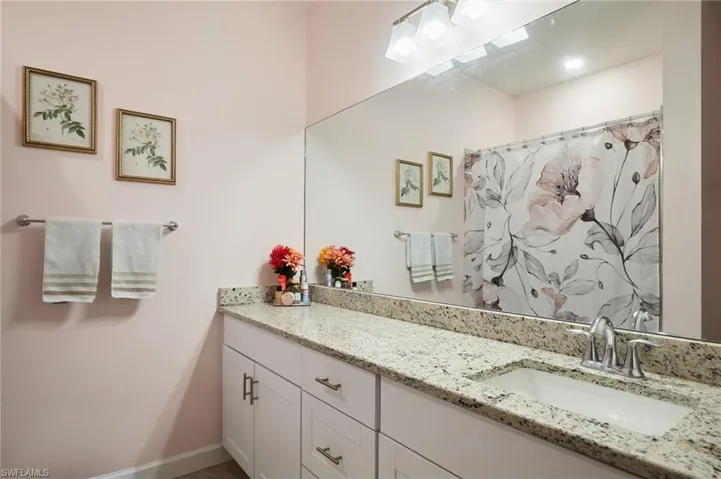 Bathroom featuring vanity and a shower with shower curtain