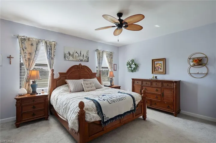 Carpeted bedroom with ceiling fan